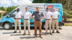 James Wisler & technicians standing by a Wisler company truck.
